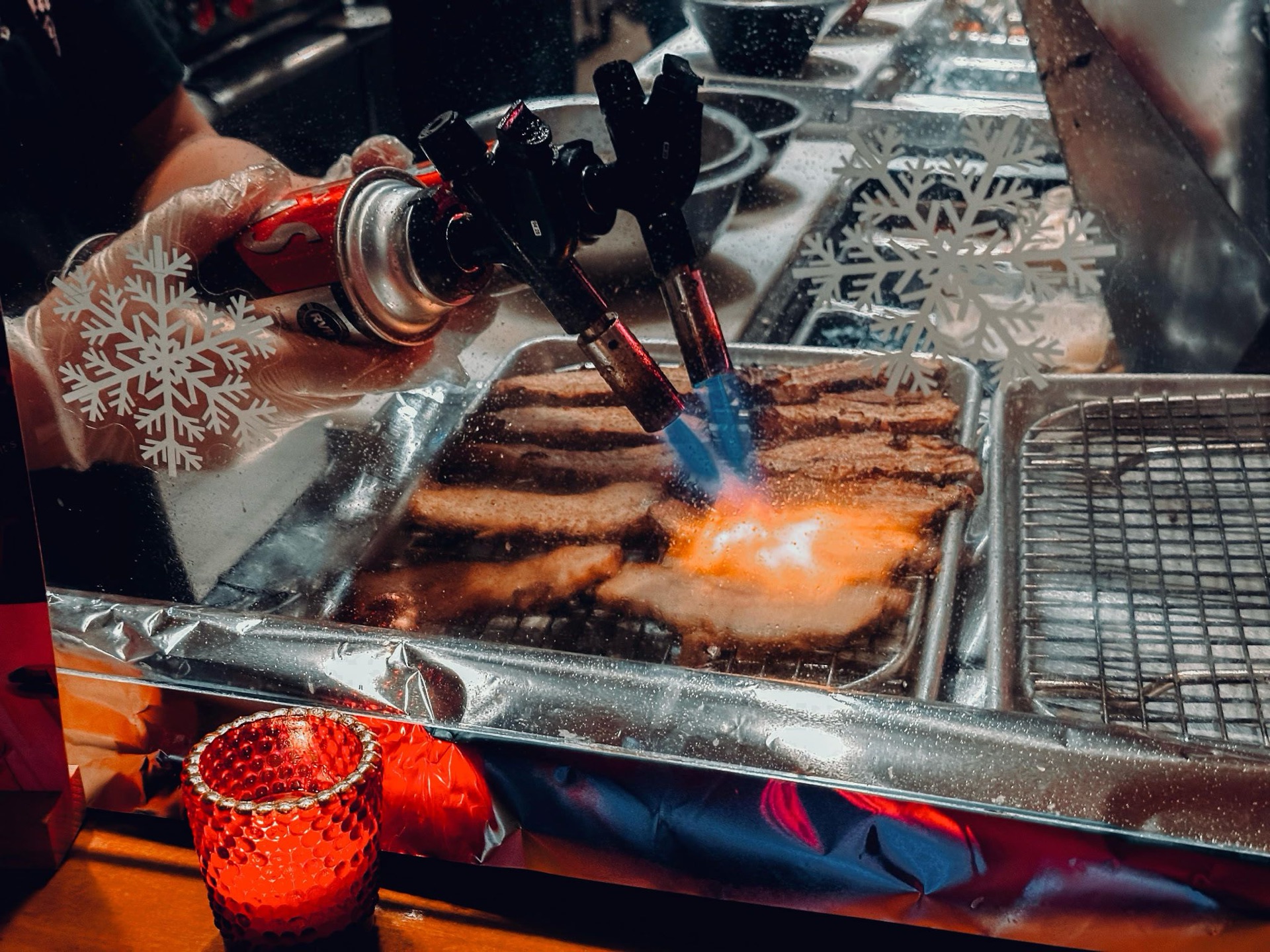 Mr. Taka chef using a torch to smoke-finish thick-cut chashu pork belly