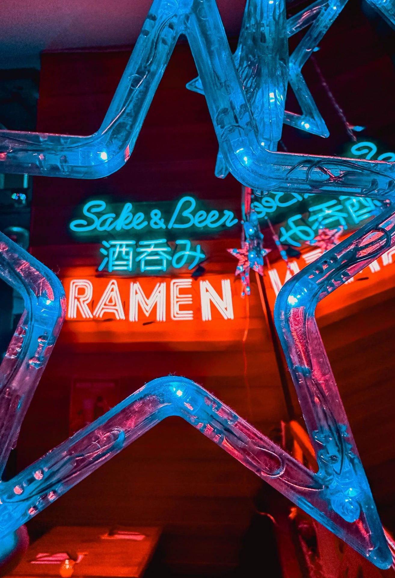 Mr. Taka Ramen neon sign — Sake & Beer Ramen — glowing blue and red