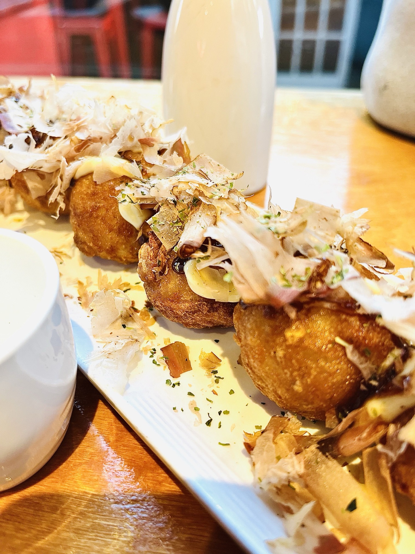 Takoyaki deep-fried octopus balls topped with bonito flakes and otafuku sauce